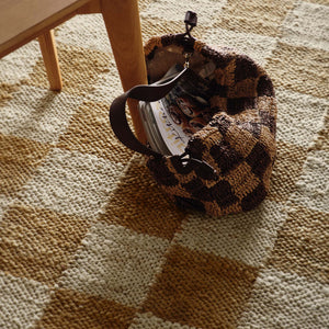 Close-up of Checkerboard Jute Natural Rug with natural and brown checkerboard pattern.