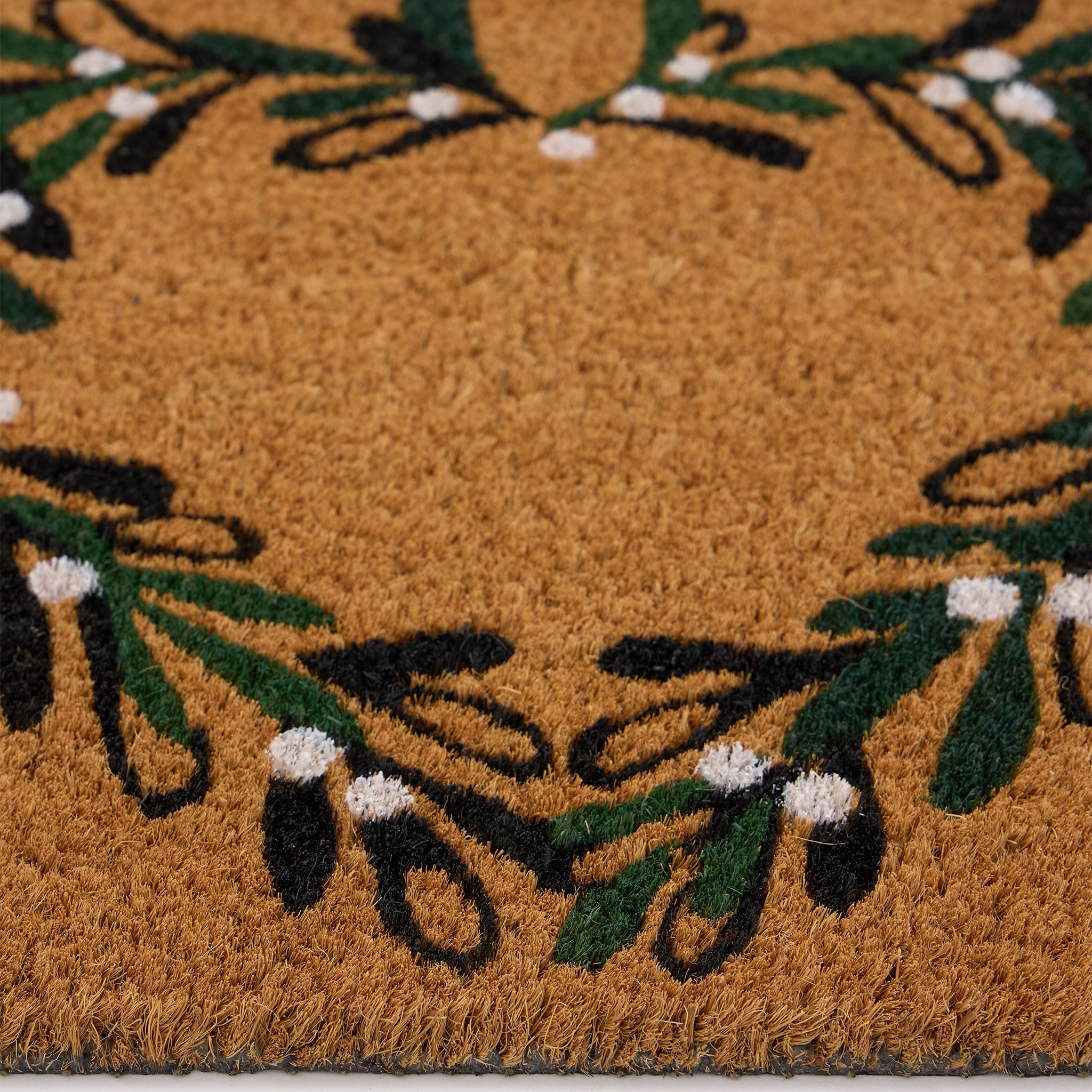 Discover the Christmas Mistletoe Heart Coir Doormat- a coir doormat featuring a heart wreath decorated with mistletoe. 