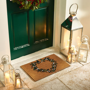 Discover the Christmas Mistletoe Heart Coir Doormat- a coir doormat featuring a heart wreath decorated with mistletoe. 