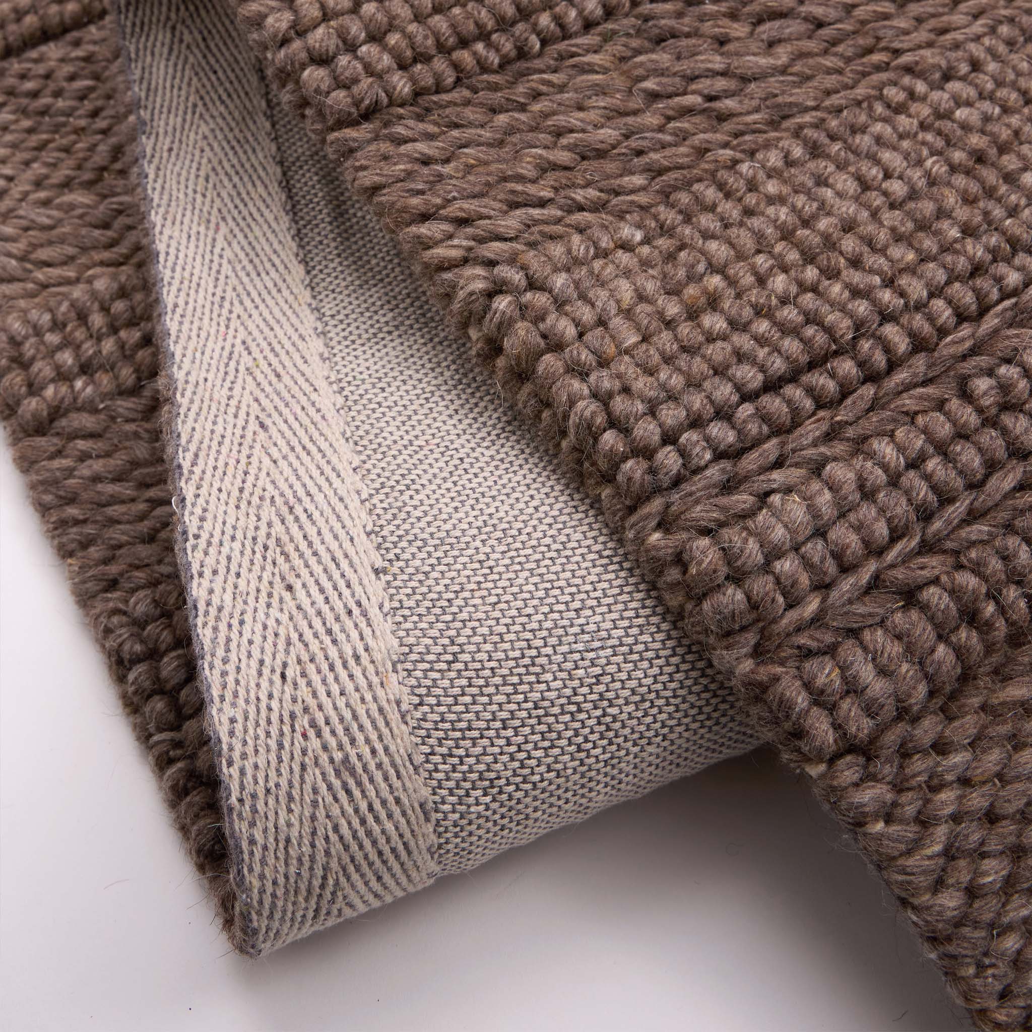 Chunky Knit Rug Brown- 100% wool rug featuring a knitted pattern in brown.