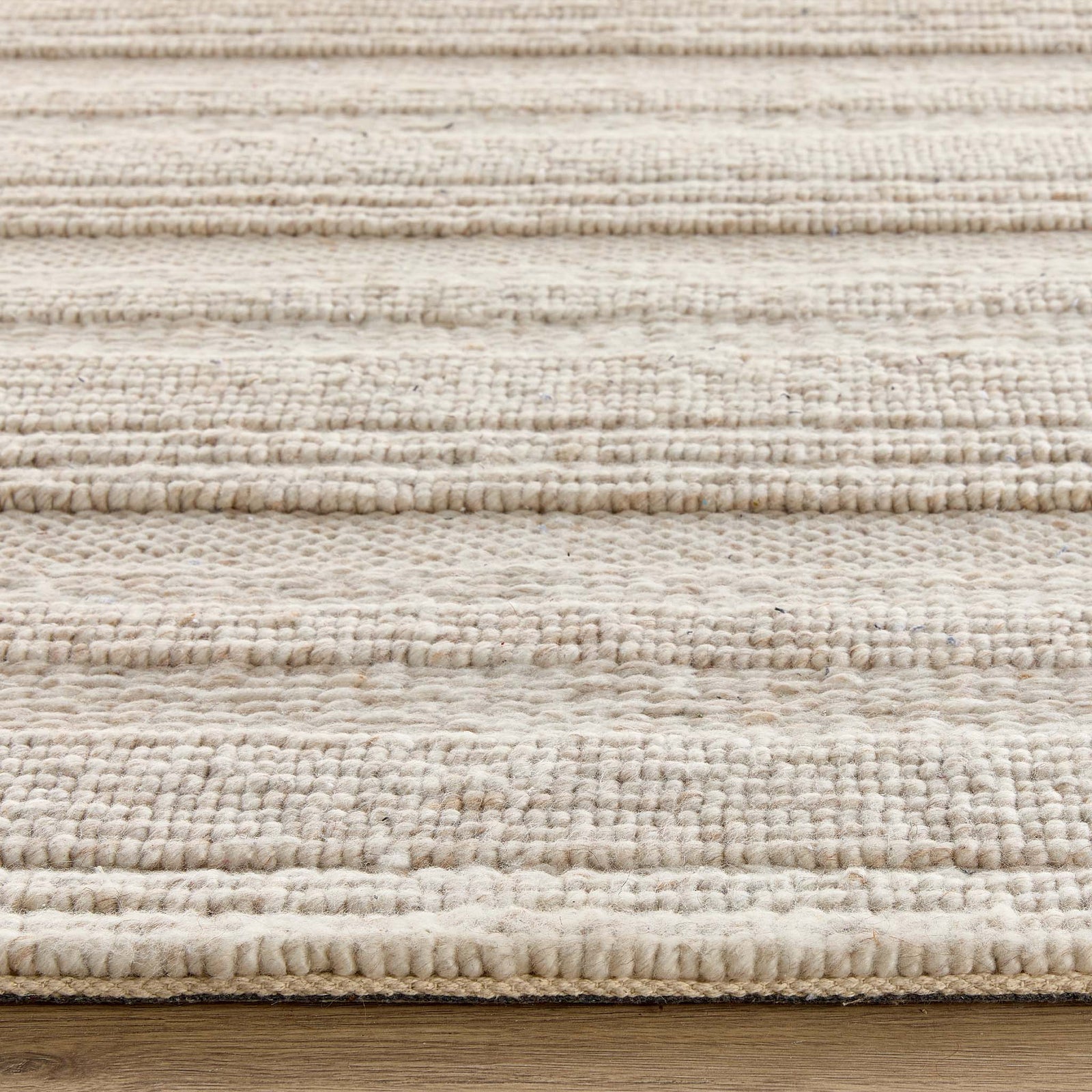 Close-up of the Chunky Knit Cream Wool Rug showing the pile height and the knitted pattern design.