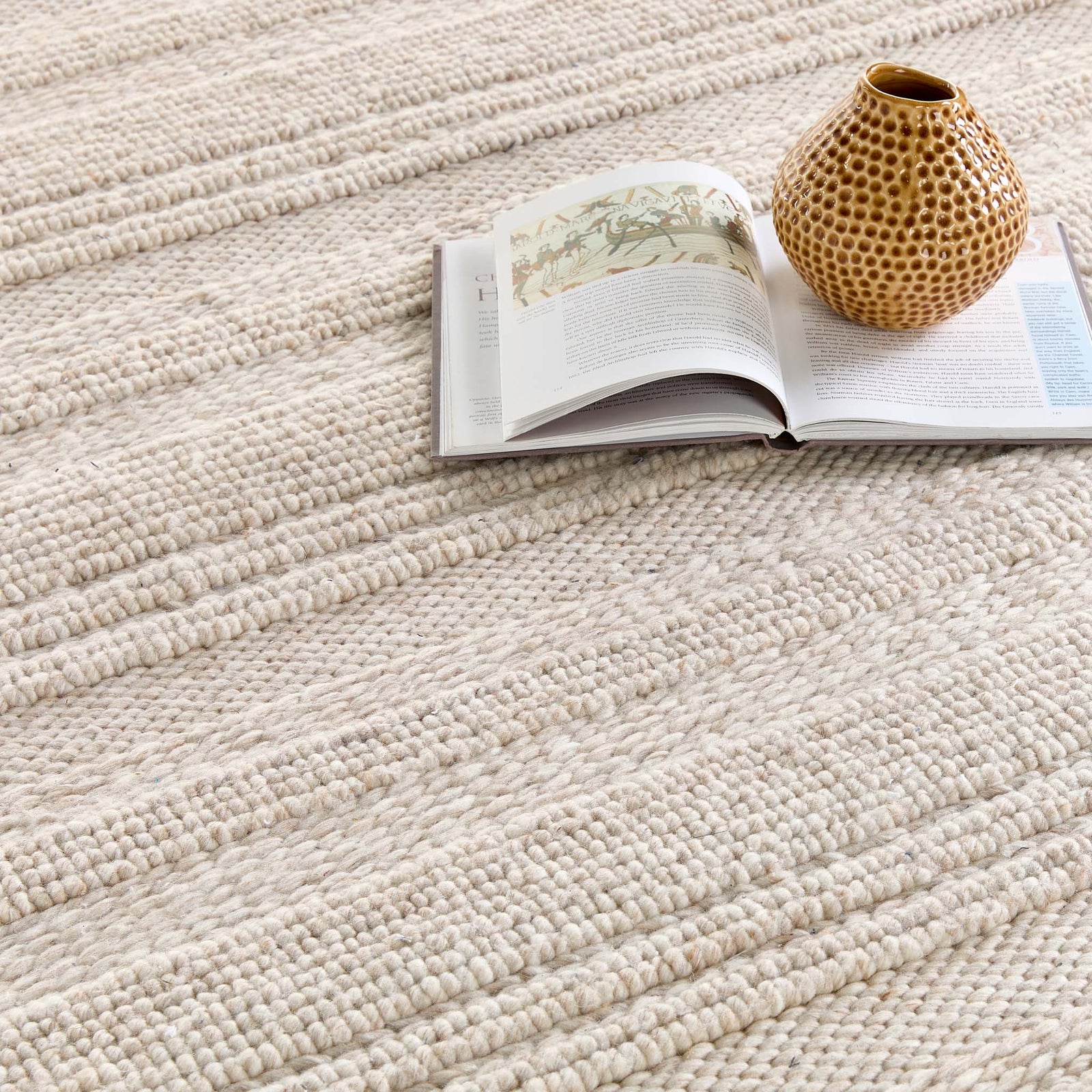 Close-up of the Chunky Knit Cream Wool Runner with a knitted pattern design.