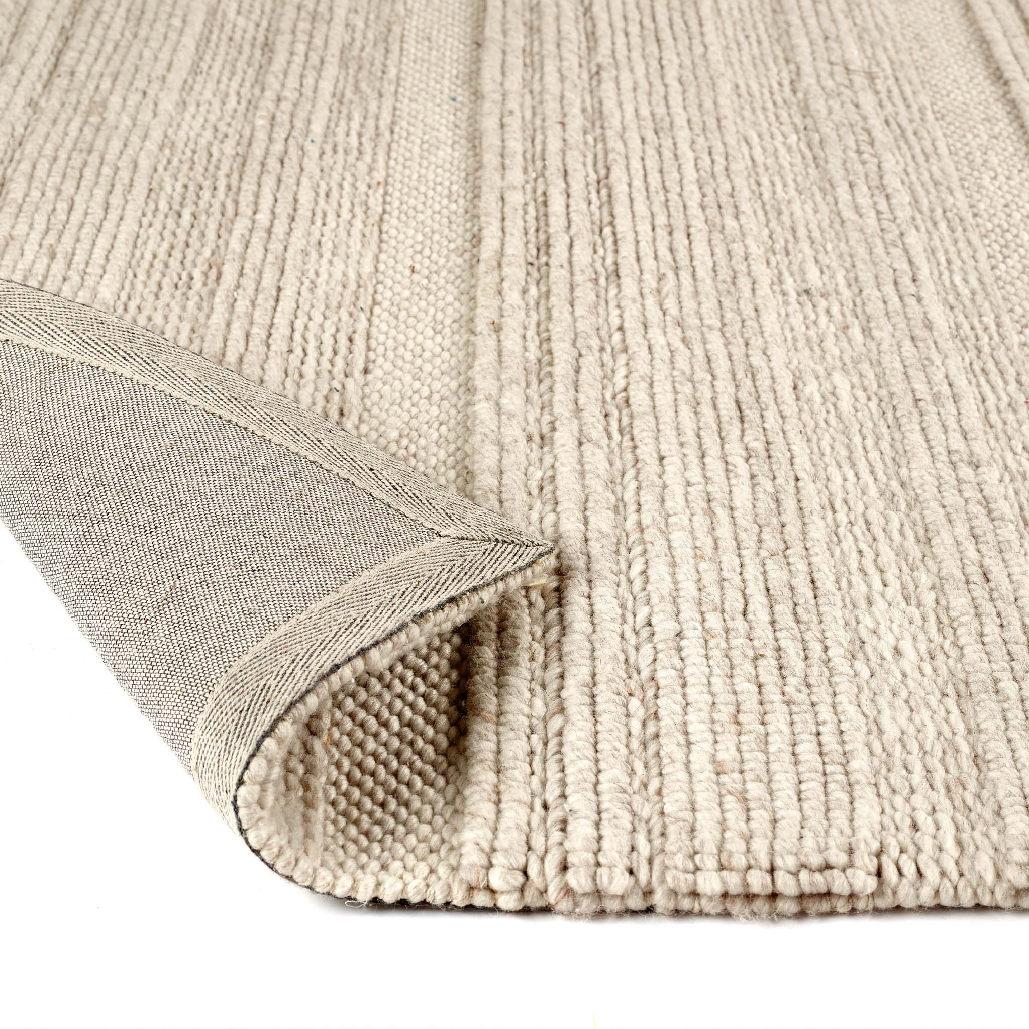 Close-up of the Chunky Knit Cream Wool Rug showing backing and the knitted design.