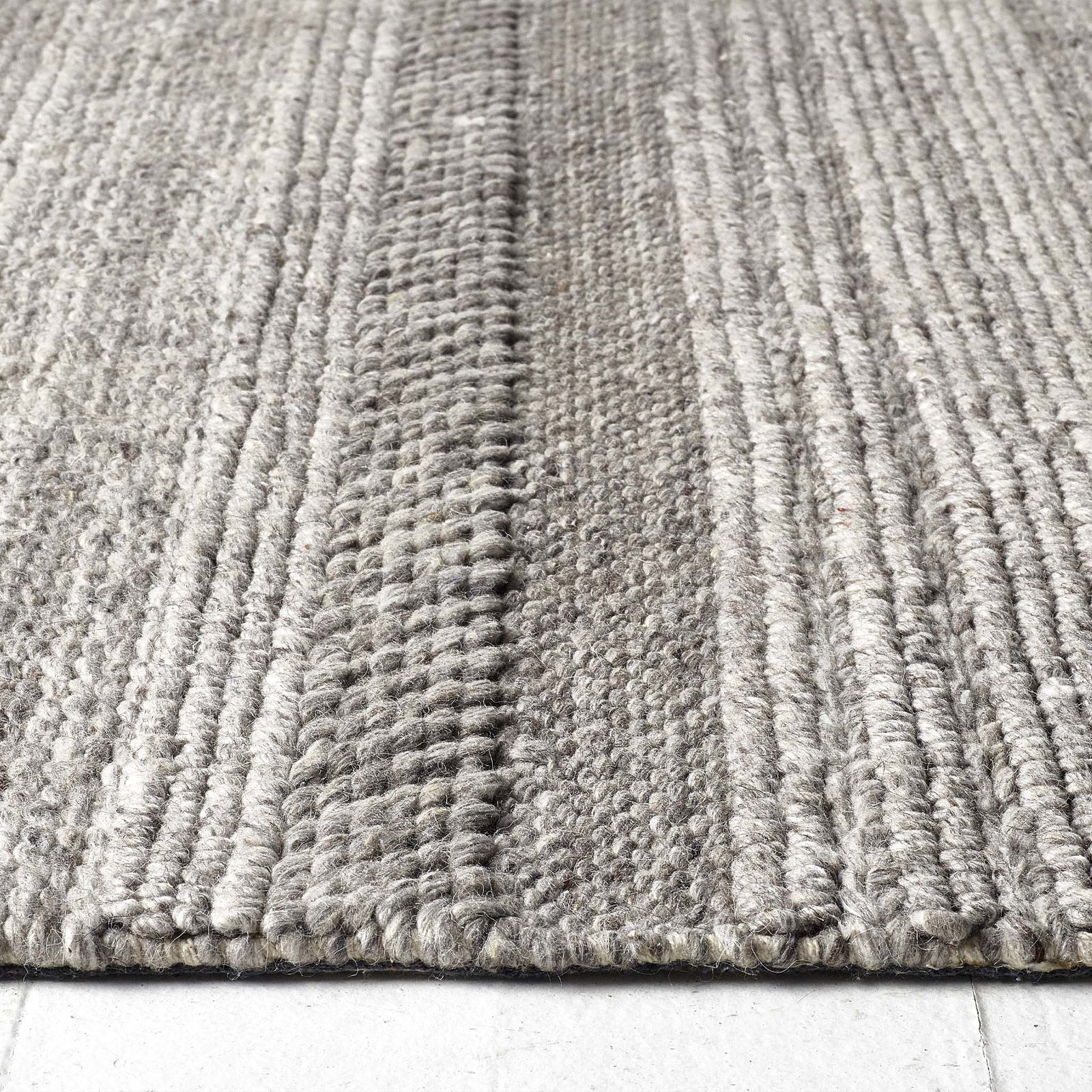 Close-up of Chunky Knit Grey Wool Rug showing pile height and the knitted pattern design.