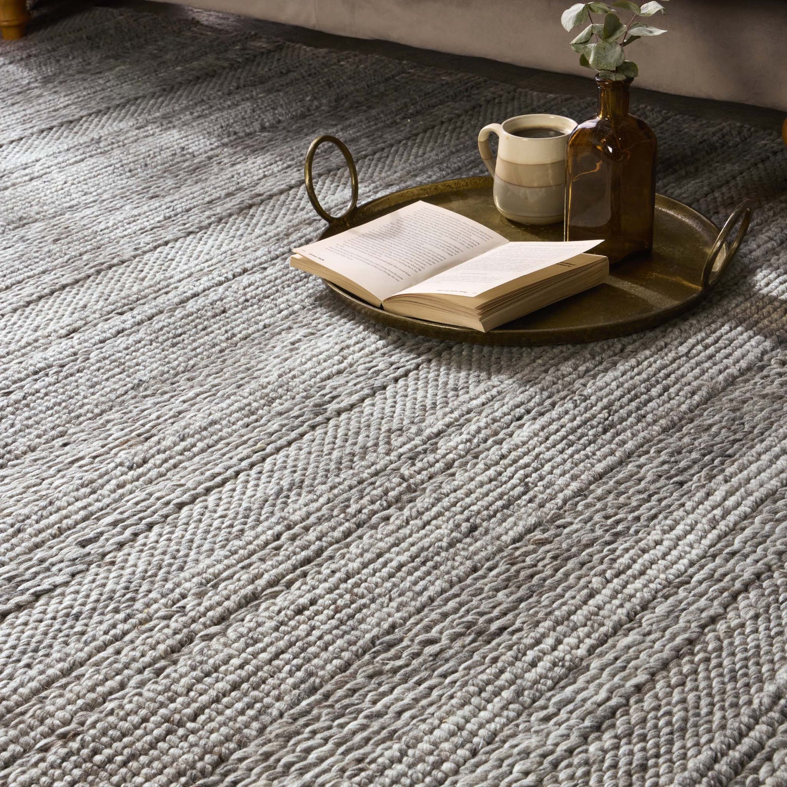 Close-up of Chunky Knit Grey Wool Rug with a knitted pattern design.