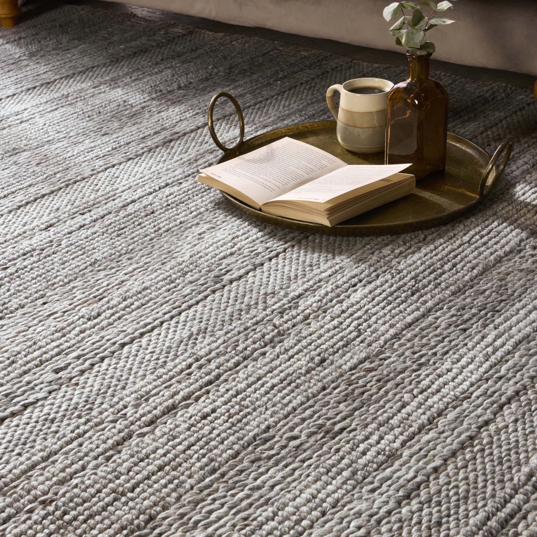 Close-up of Chunky Knit Grey Wool Rug with a knitted pattern design.