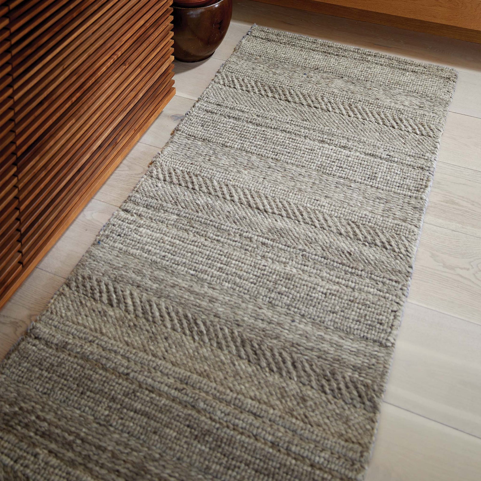 Chunky Knit Grey Wool Runner with a knitted pattern design, styled by the stairs.