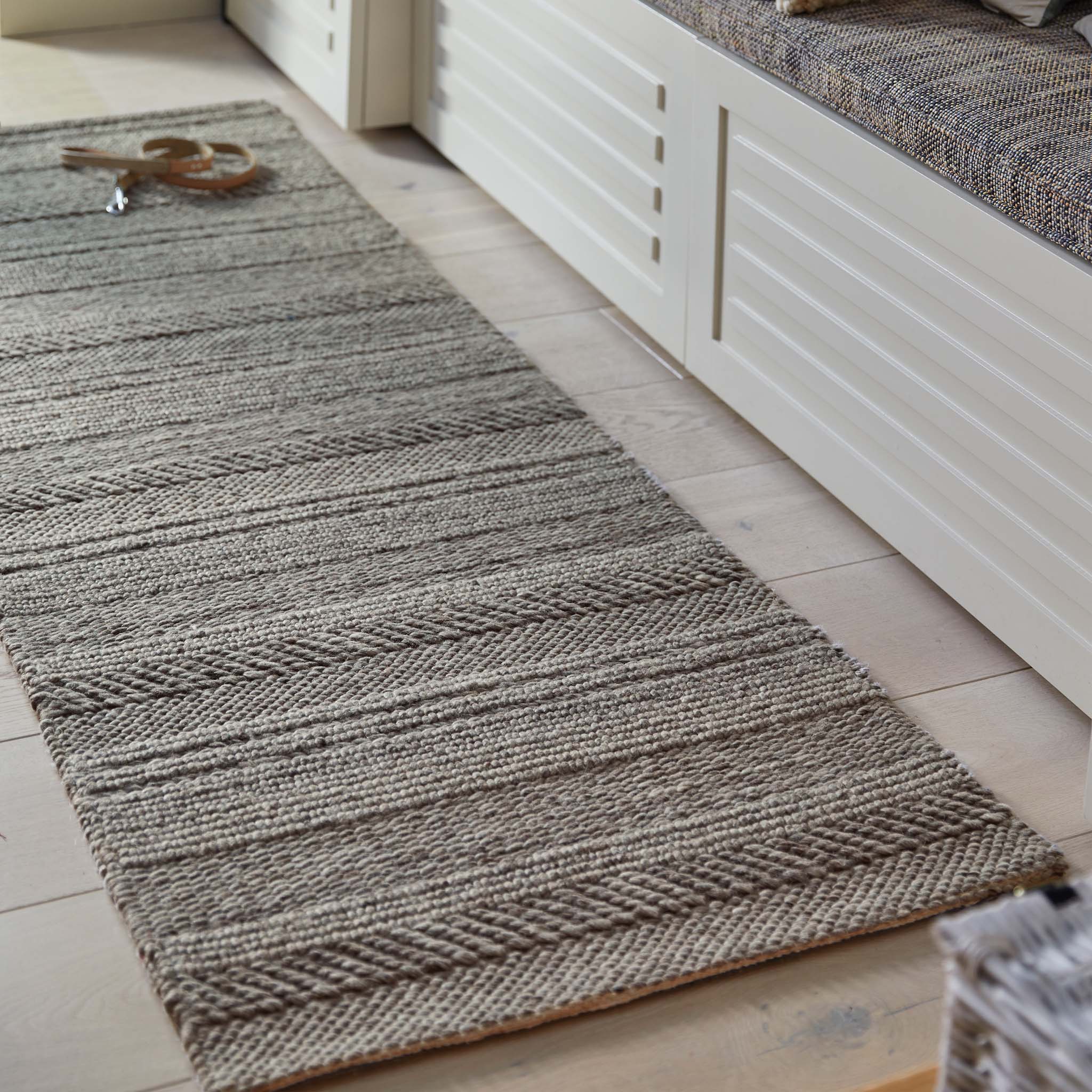 Chunky Knit Grey Wool Runner with a knitted pattern design, styled by a bench.