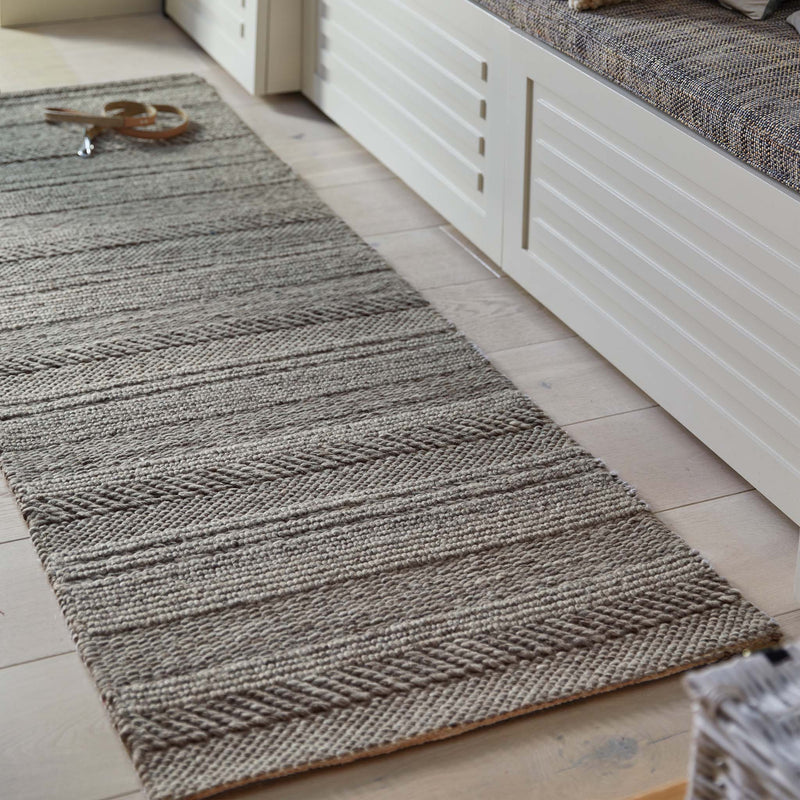 Chunky Knit Grey Wool Runner with a knitted pattern design, styled by a bench.