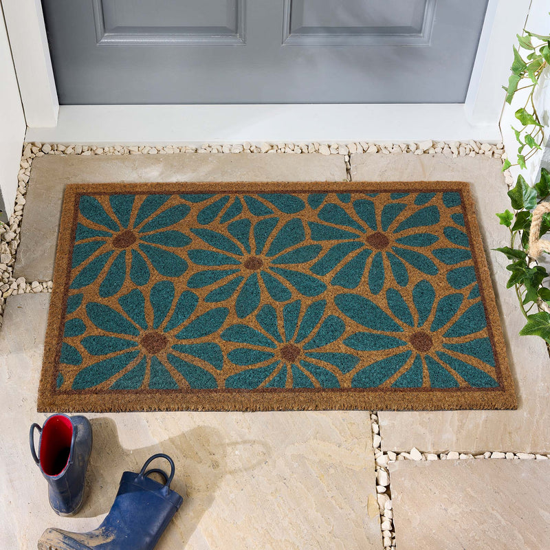 Boho Floral Coir Doormat with a blue floral design, styled in a doorway. 