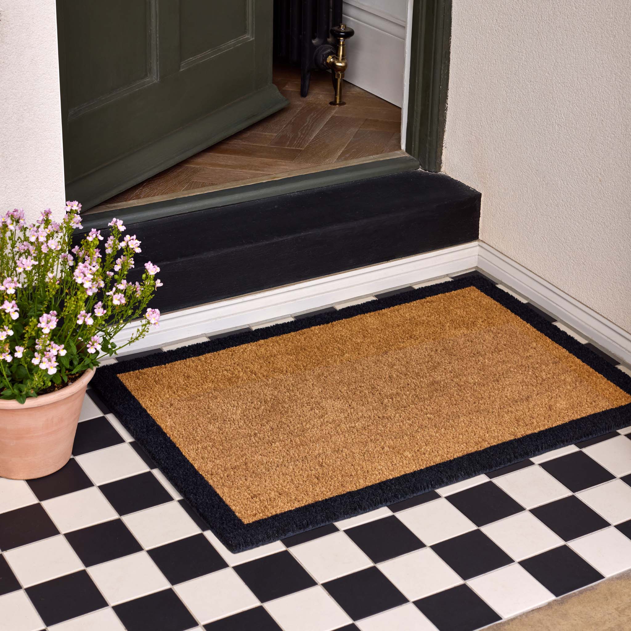 Printed Coir Border Black Doormat. Made from eco-friendly materials featuring a black border. 