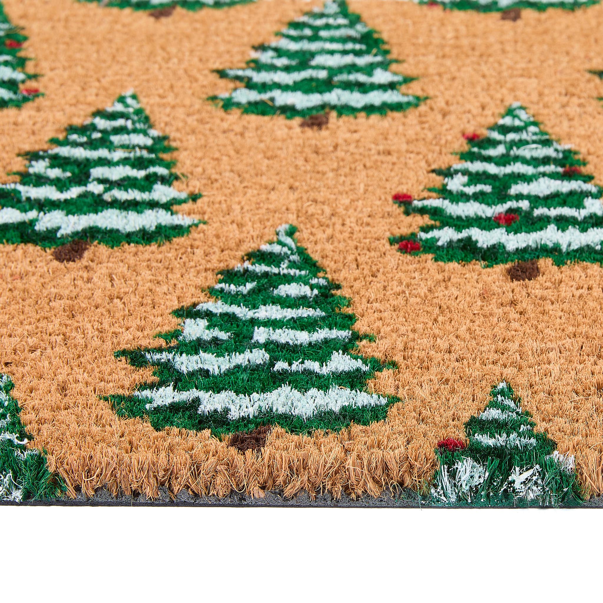 Close-up of Christmas Trees Coir Doormat showing the pile height and the snow dusted Christmas tree design.