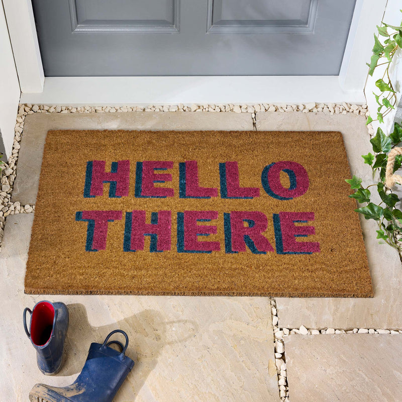 Hello There Coir Doormat - a 100% recycled material coir doormat featuring 'hello there' written in pink and blue lettering.