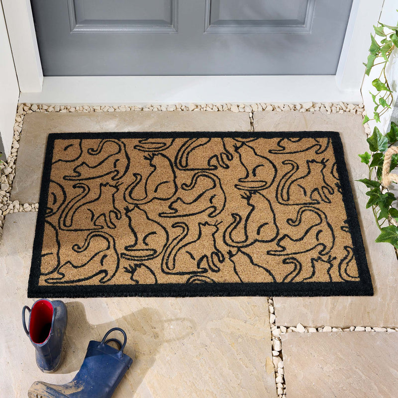 Outline Cats Black Coir Doormat with black outlined cats and a black border, styled in a doorway.