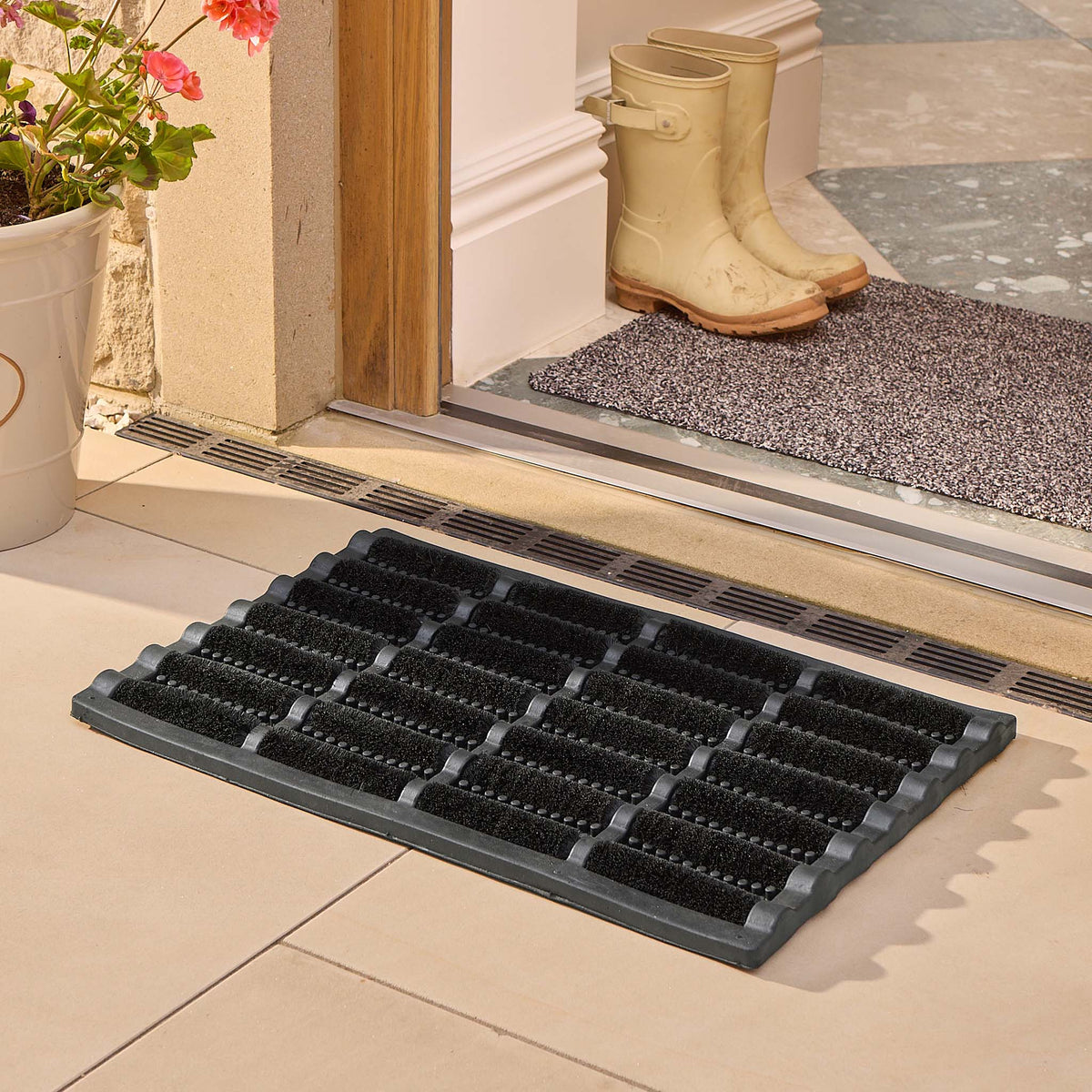 Coir Scraper Doormat Black styled on tiled flooring. 