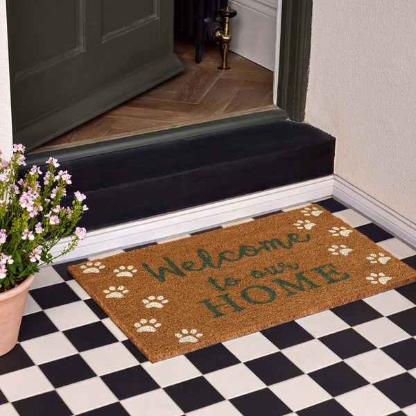 Welcome Paws Coir Doormat- made from natural coconut husks fibres featuring a paw print border with 'welcome to our home' written in the middle.