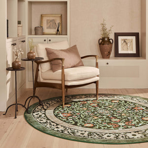 Country Paisley Green Eco-Washable Circle Rug with a floral design, styled on wooden flooring.