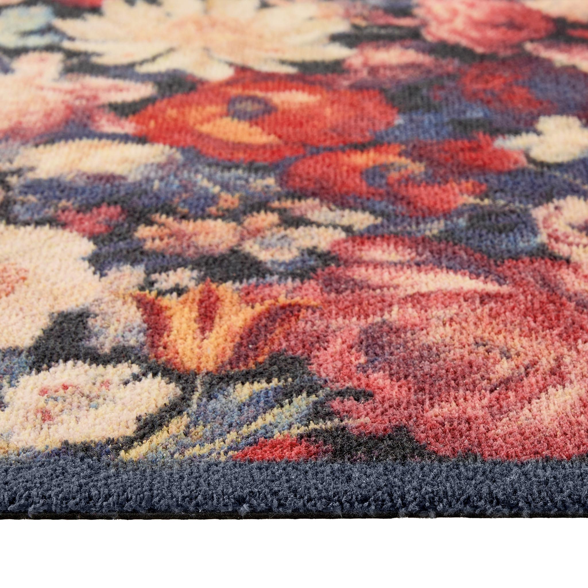 Dark Florals Washable Runner- a 100% recycled cotton runner featuring oversized floral blooms in shades of red, cream, orange, and pink against a navy backdrop.