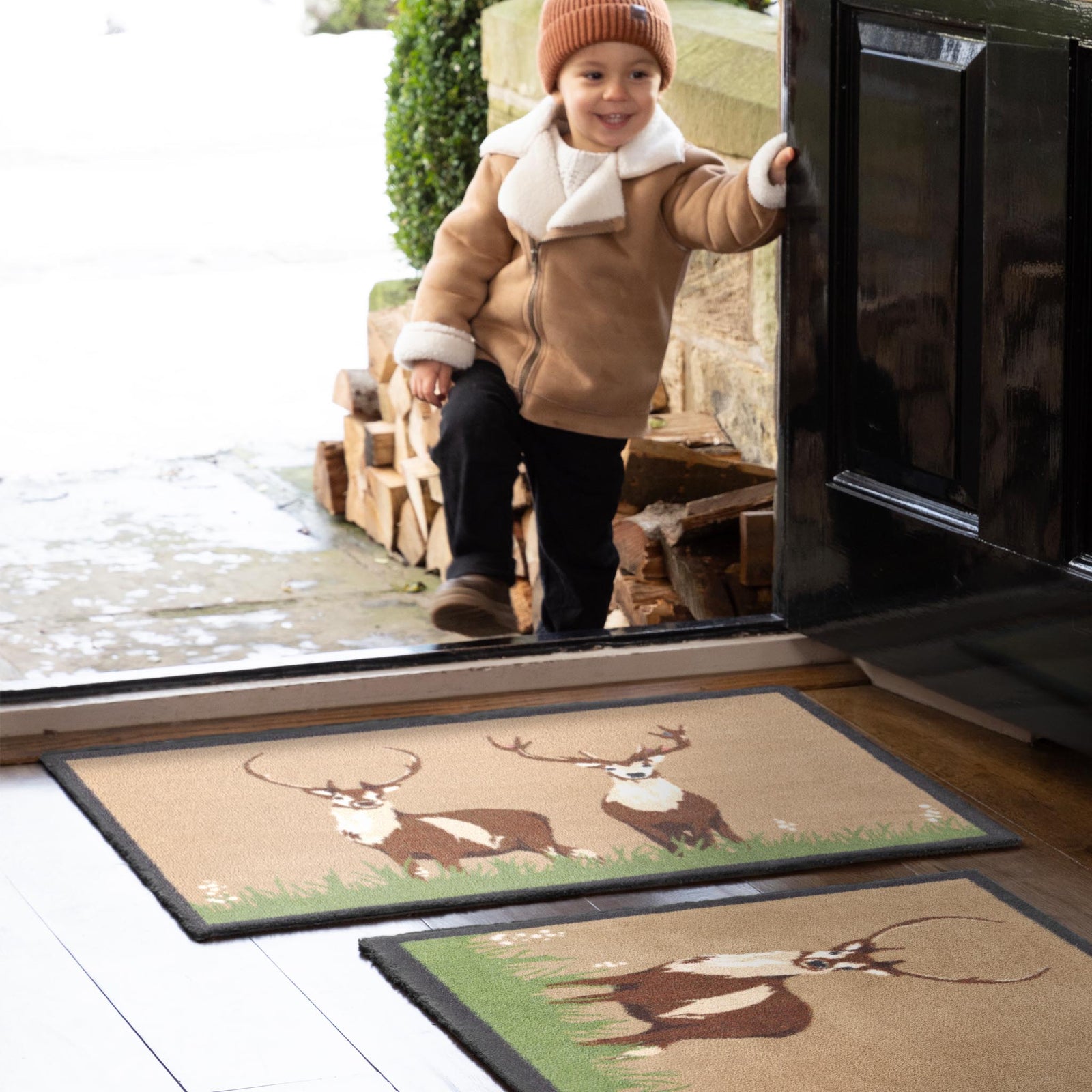 Deer 1 Beige Washable Cotton Doormat with two deers in grass design, styled in an entryway.
