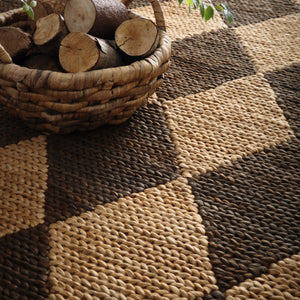 Close-up of Diamond Jute Natural/Brown Rug with a natural and brown diamond pattern.