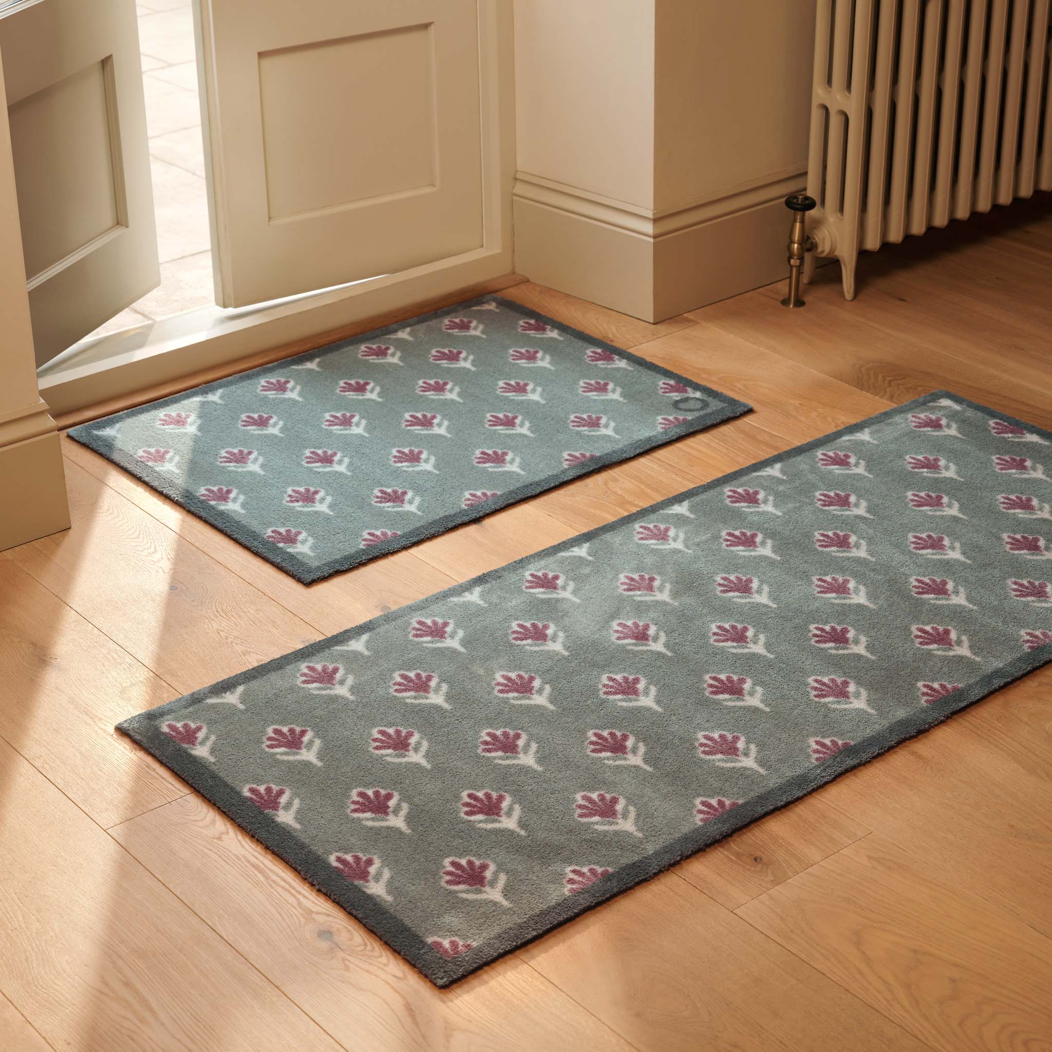 Disty Floral Green Doormat- 100% recycled cotton doormat featuring a woodblock pattern of purple flowers.