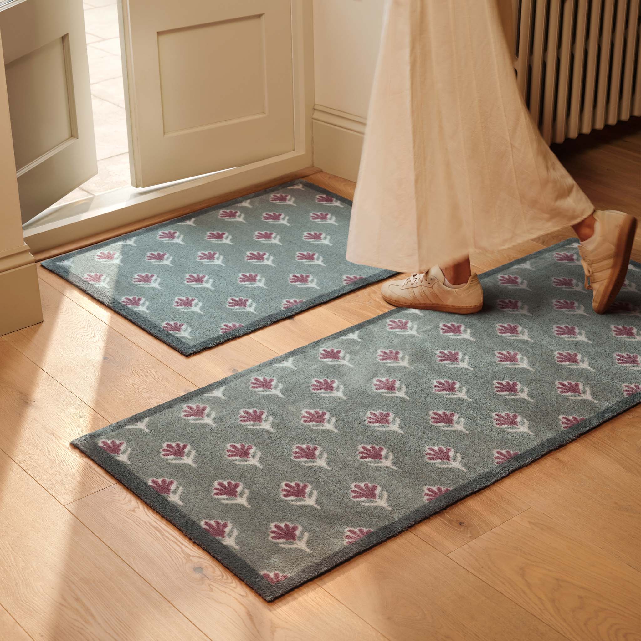 Ditsy Floral Green Runner- 100% recycled runner featuring a woodblock pattern of purple flowers.