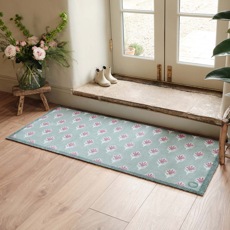 Ditsy Floral Green Runner- 100% recycled runner featuring a woodblock pattern of purple flowers.