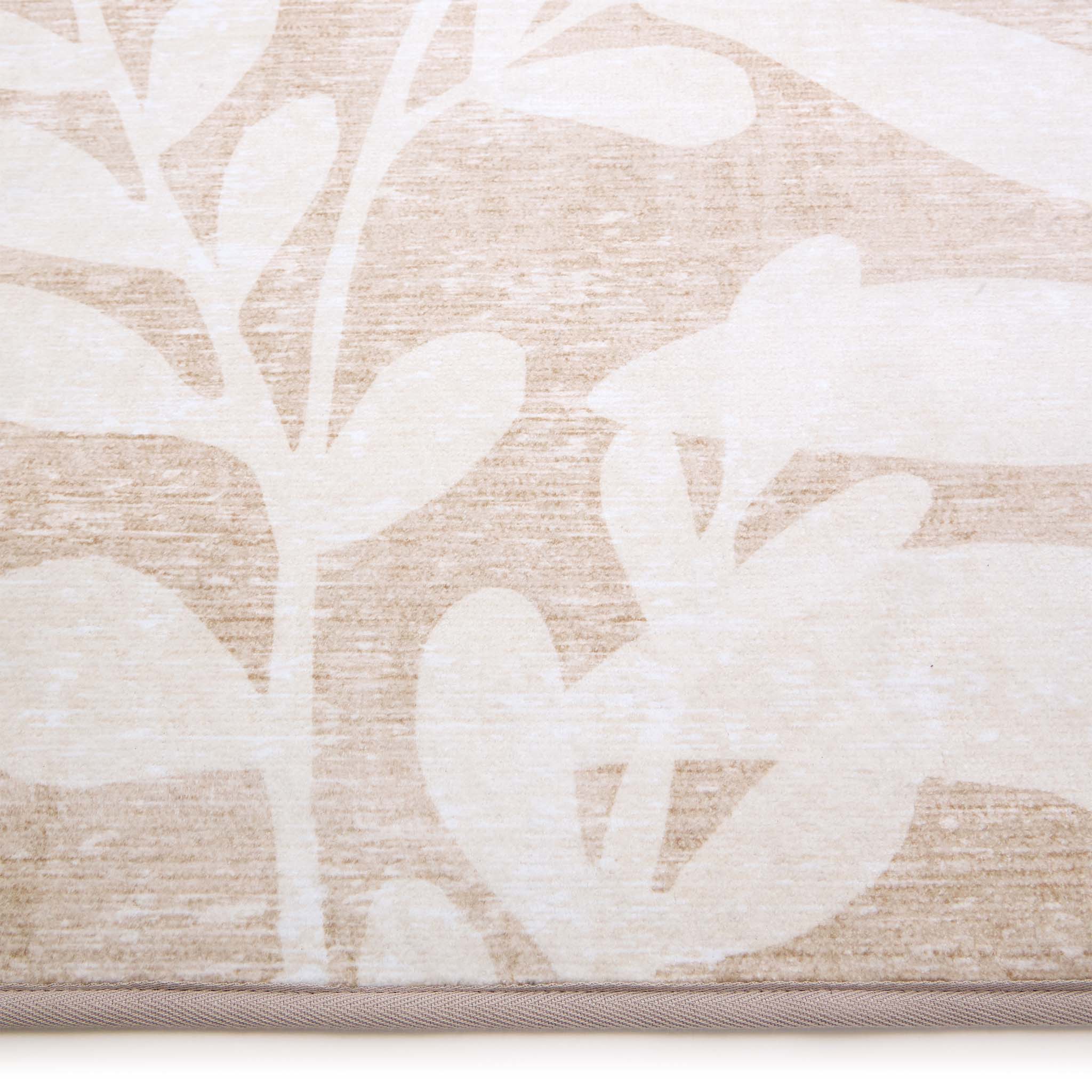 Eden Leaves Natural Eco-Washable Rug- 100% recycled polyester rug featuring a white floral pattern.