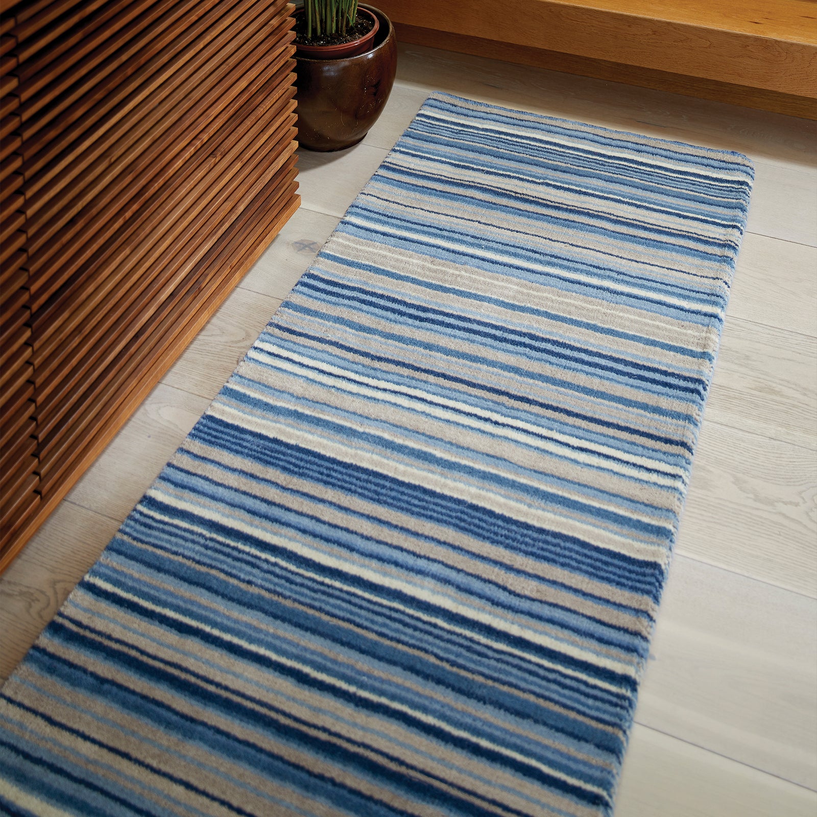 Fine Stripes Blue Beige Wool Runner with a stripe design, styled by the stairs.