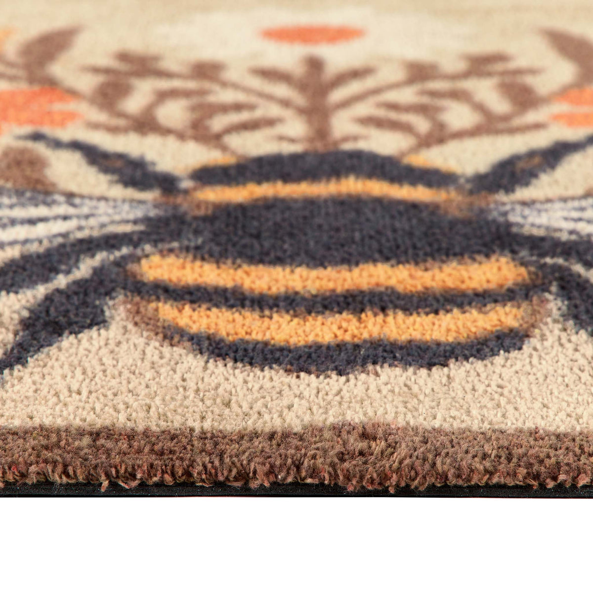Close-up of Floral Bee Beige Charity Doormat with a floral bee design.