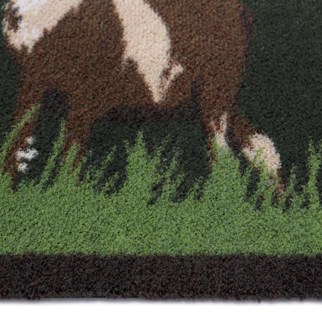 Green Deer Washable Doormat- a cotton doormat featuring two deers resting on green grass, surround by delicate white wildflowers.