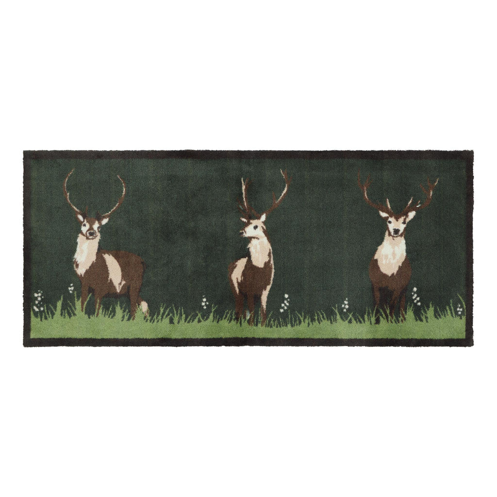 Green Deer Washable Runner- a cotton runner featuring three deers resting on green grass, surround by delicate white wildflowers.