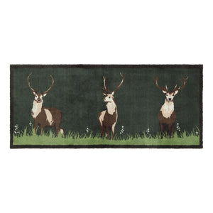 Green Deer Washable Runner in green- a 100% recycled cotton runner featuring three deer resting on green grass, surrounded by white wildflowers.