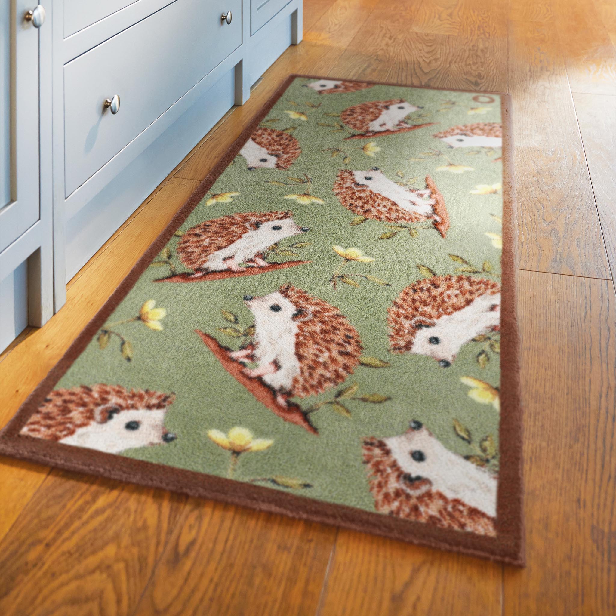 Hedgehog Friends Washable Runner in Sage Green- a 100% recycled cotton runner featuring hand-painted hedgehogs with yellow flowers.
