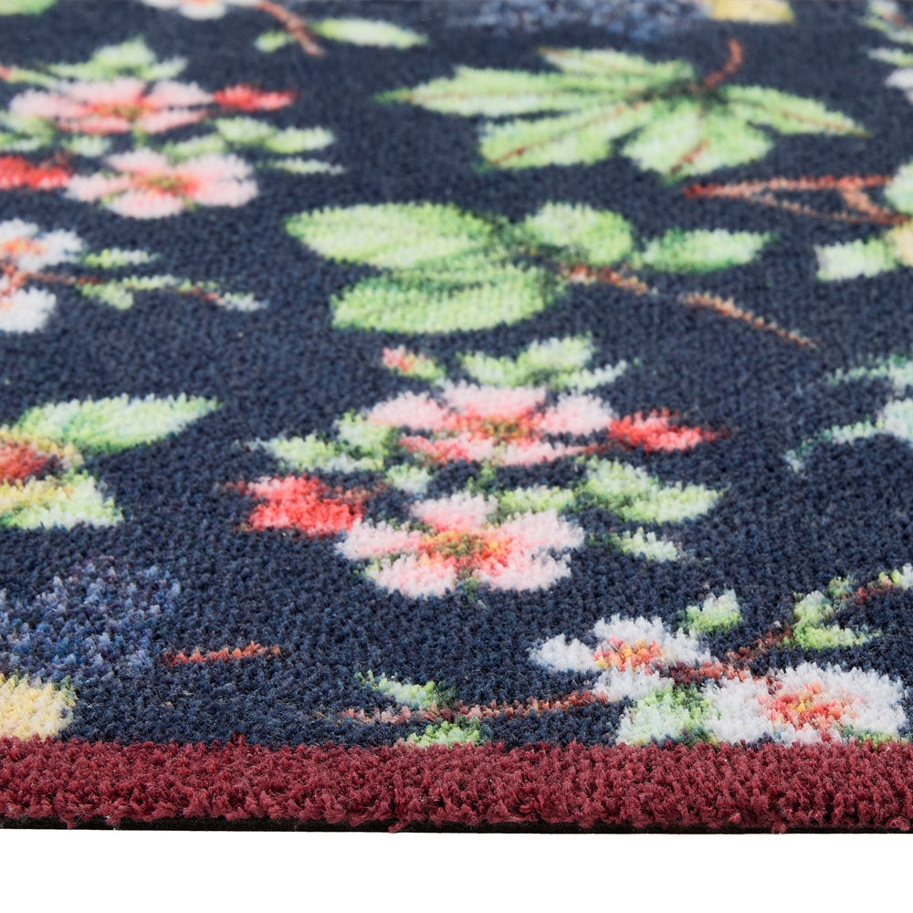 Hedgerow & Berries Washable Runner- 100% recycled cotton runner featuring dog rose, hazel and blackberries against a dark blue background. 