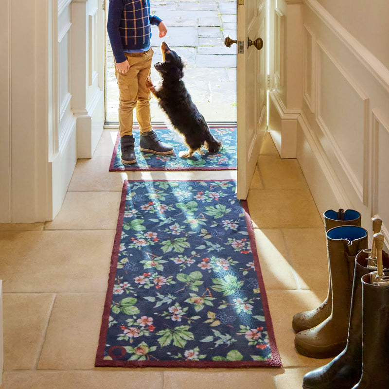 Hedgerow & Berries Washable Runner- 100% recycled cotton runner featuring dog rose, hazel and blackberries against a dark blue background. 