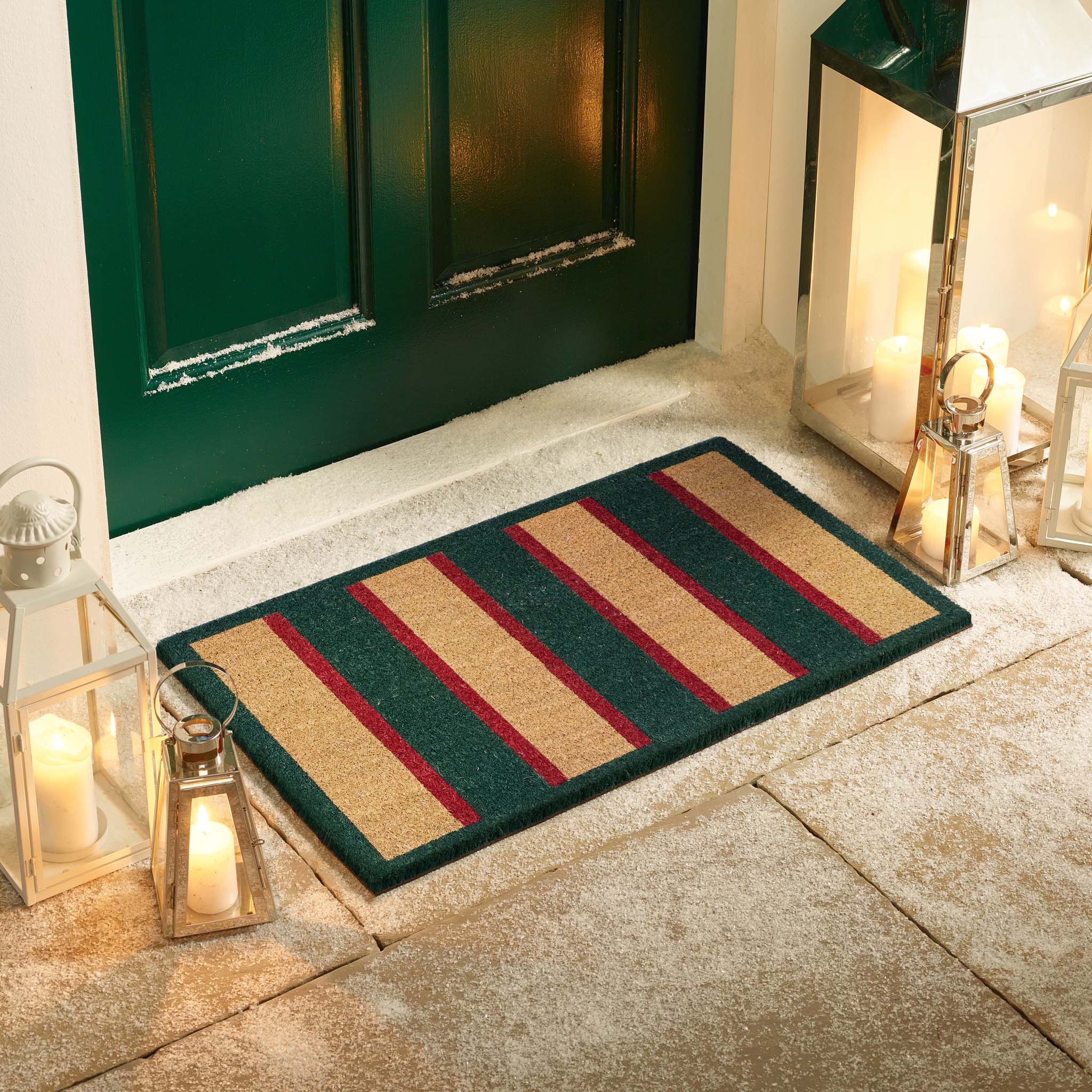 Heritage Stripe Green Coir Doormat with a red and green stripe pattern, styled in a doorway.