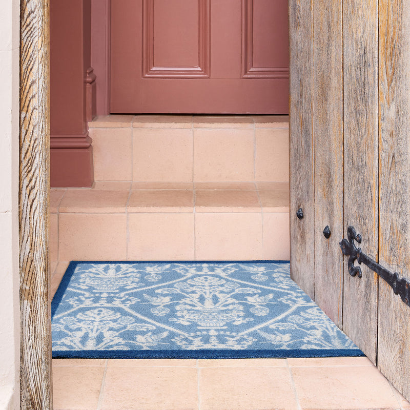 Highgrove Damask Tetbury Blue Washable Doormat with a traditional style pattern, styled on tiled flooring.