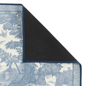 Close-up of The Highgrove Toile Tetbury Blue Eco-Washable showing a blue and white nature inspired pattern with a rubber backing. 