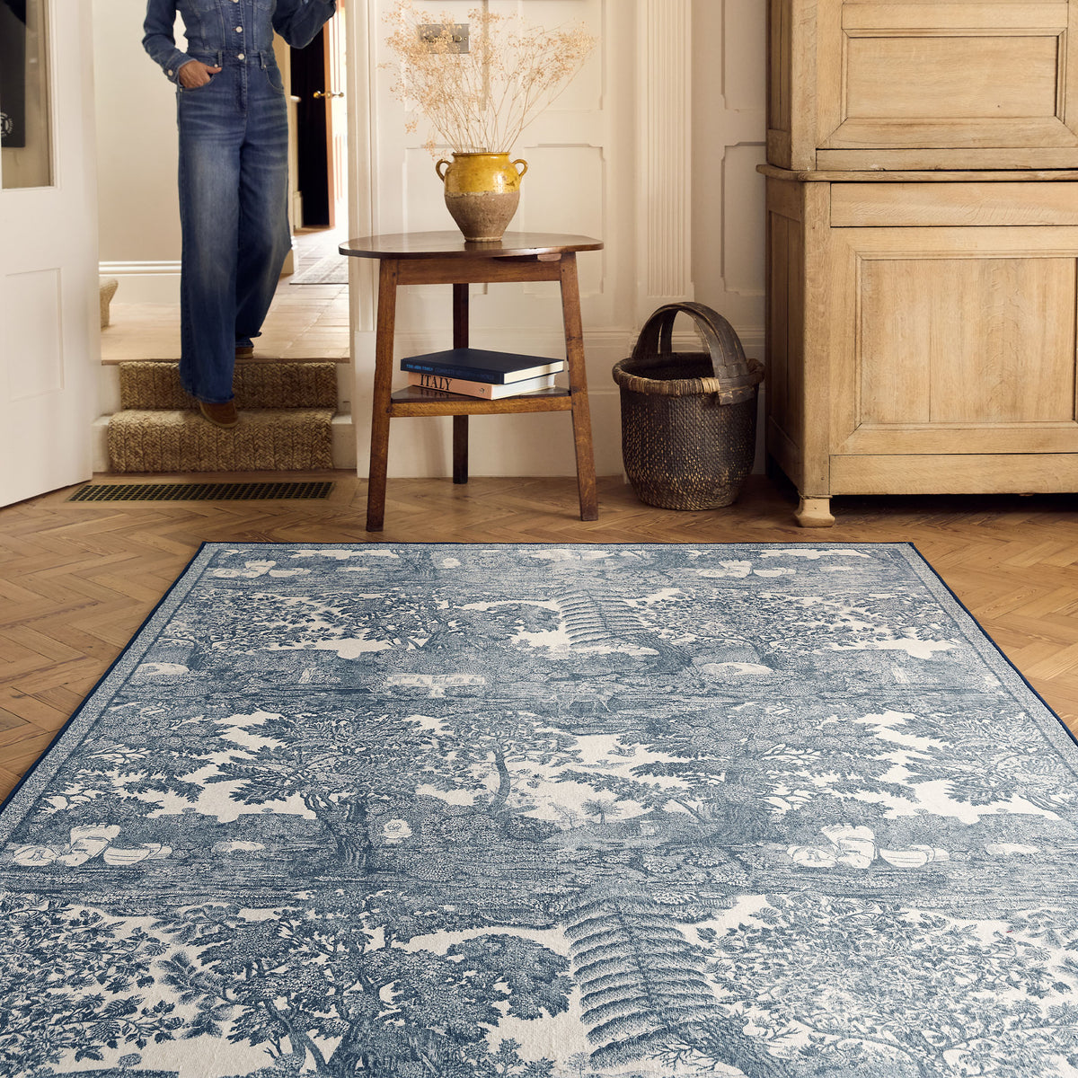 The Highgrove Toile Tetbury Blue Eco-Washable Rug with a blue and white nature inspired pattern.