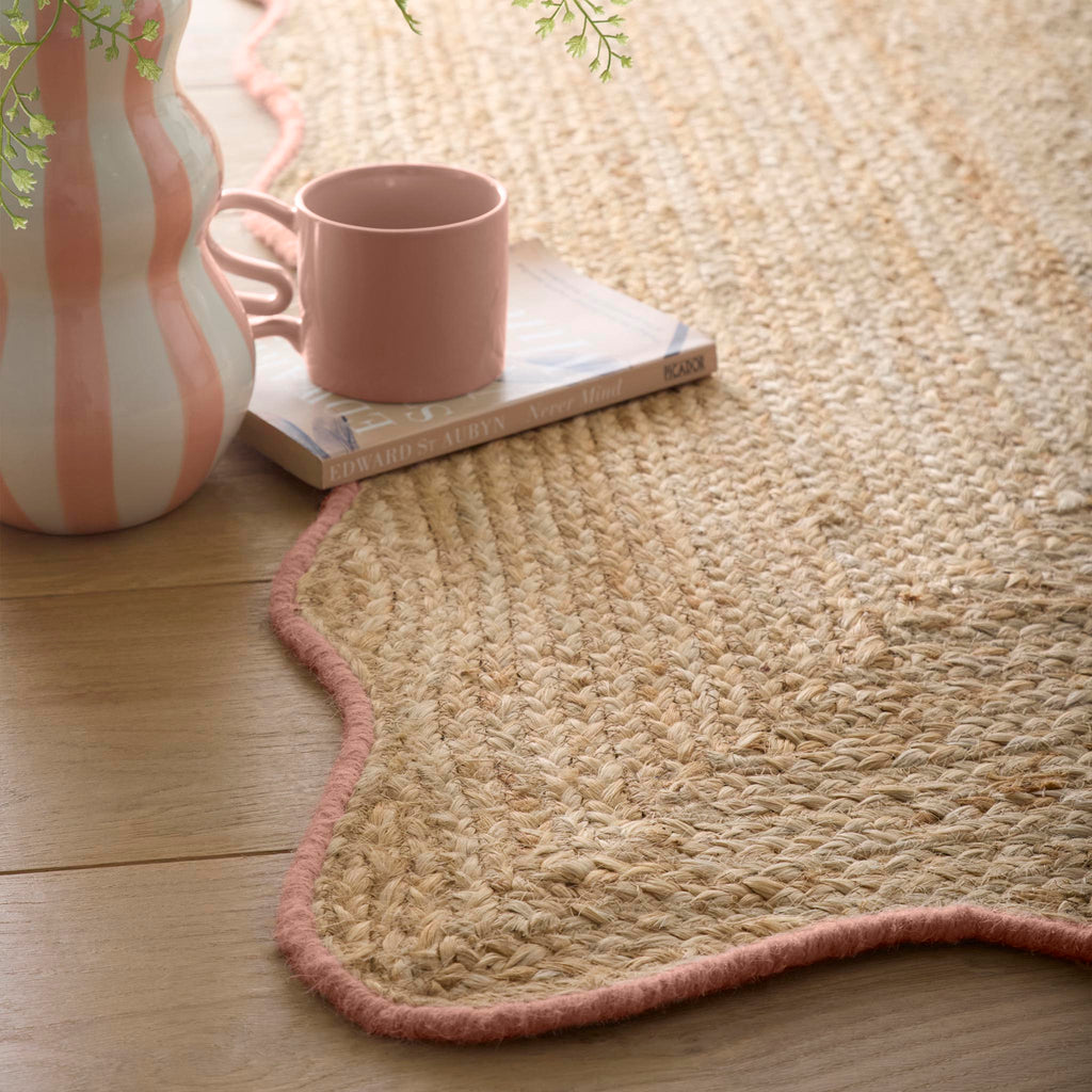 Jute Scalloped Edge Peach Rug- Jute rug wth a pink wool wiped scalloped edge.