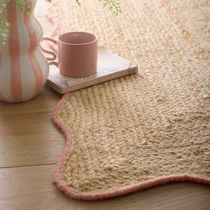 Jute Scalloped Edge Peach Rug- Jute rug wth a pink wool wiped scalloped edge.