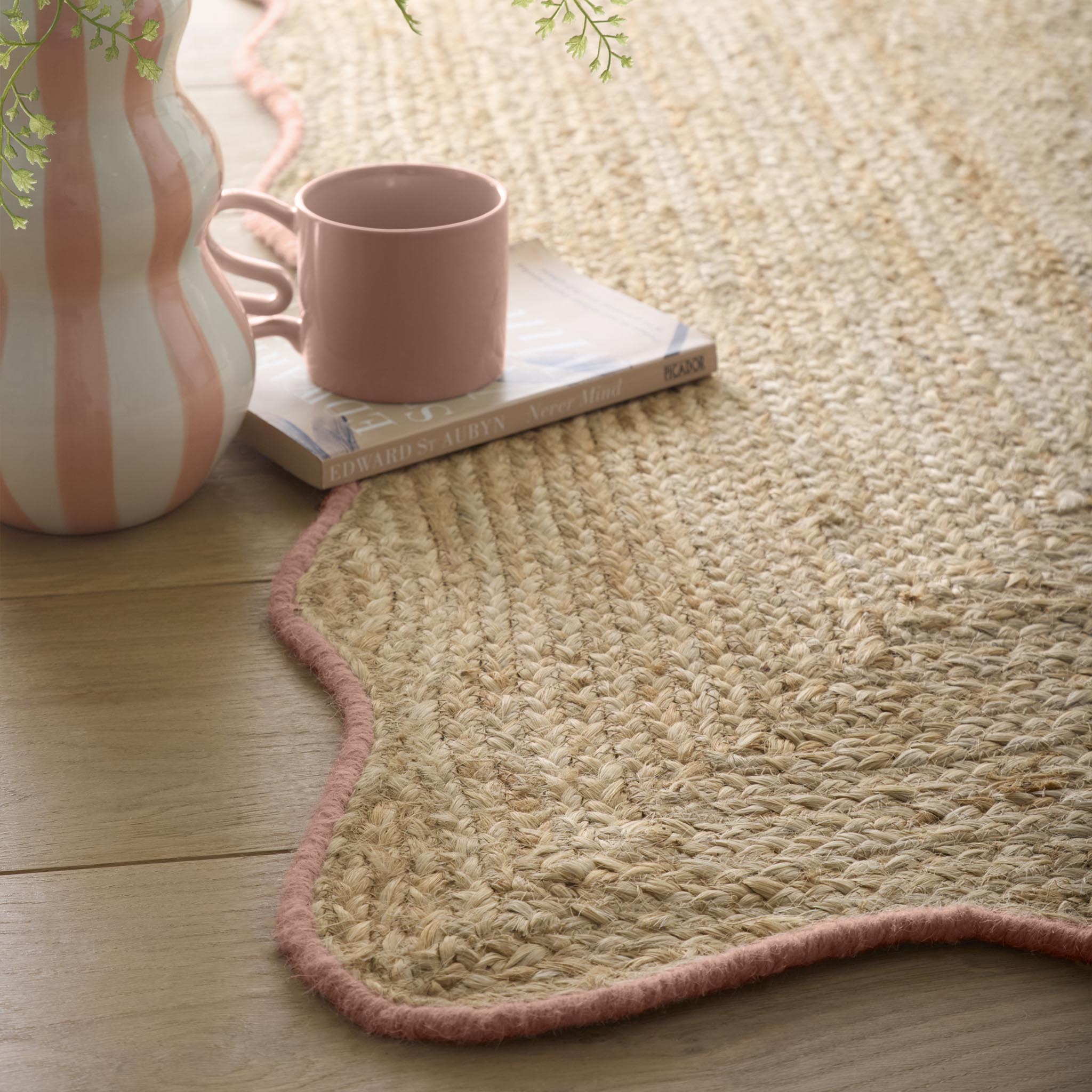Jute Scalloped Edge Peach Rug- Jute rug wth a pink wool wiped scalloped edge.