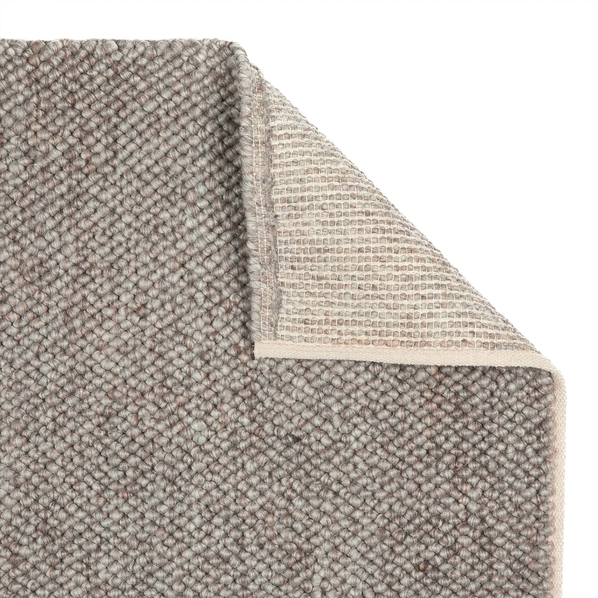 La Playa Rustic Rug showing backing and a textured design .