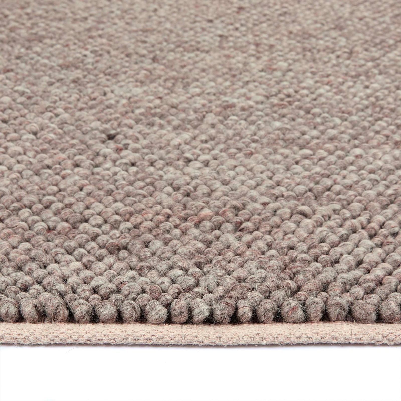 Close-up of La Playa Rustic Brown Rug showing the pile height and the textured design. 