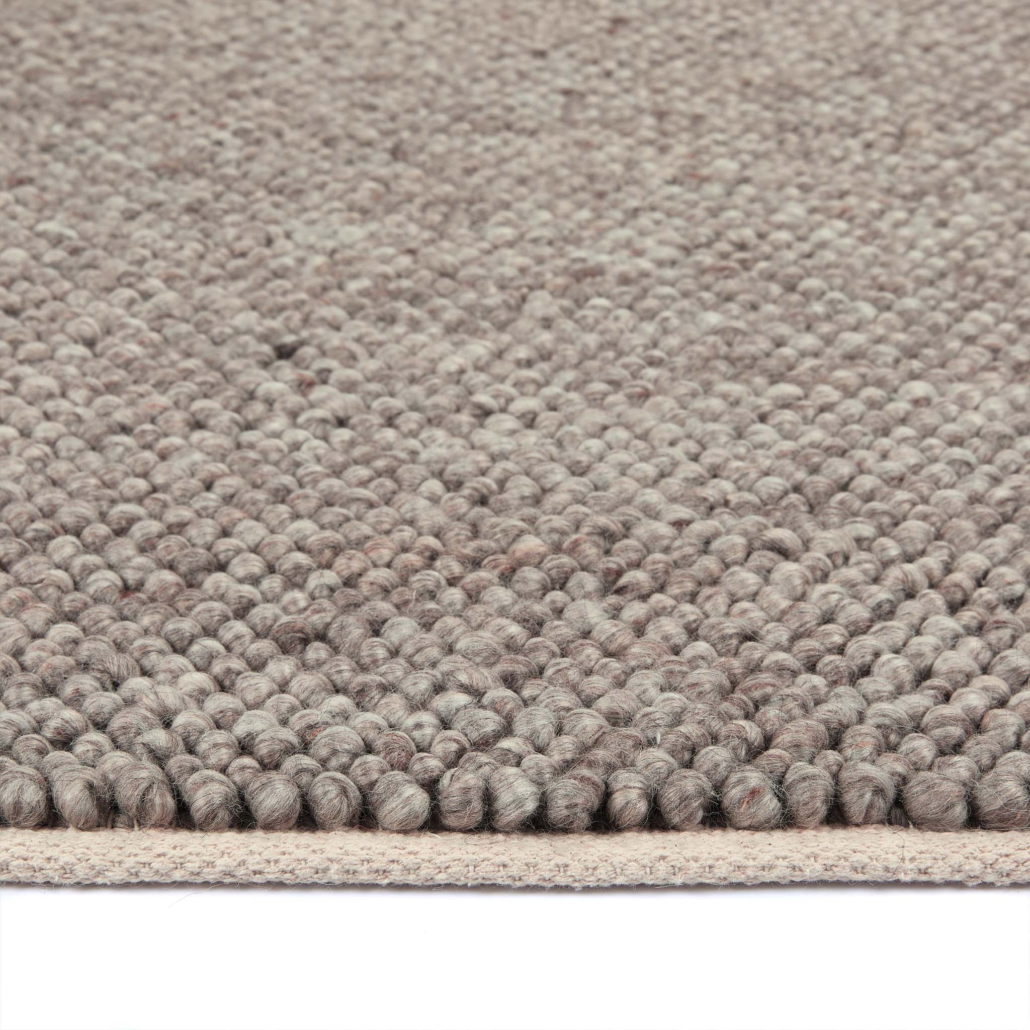 Close-up of La Playa Rustic Brown Rug showing the pile height and the textured design. 