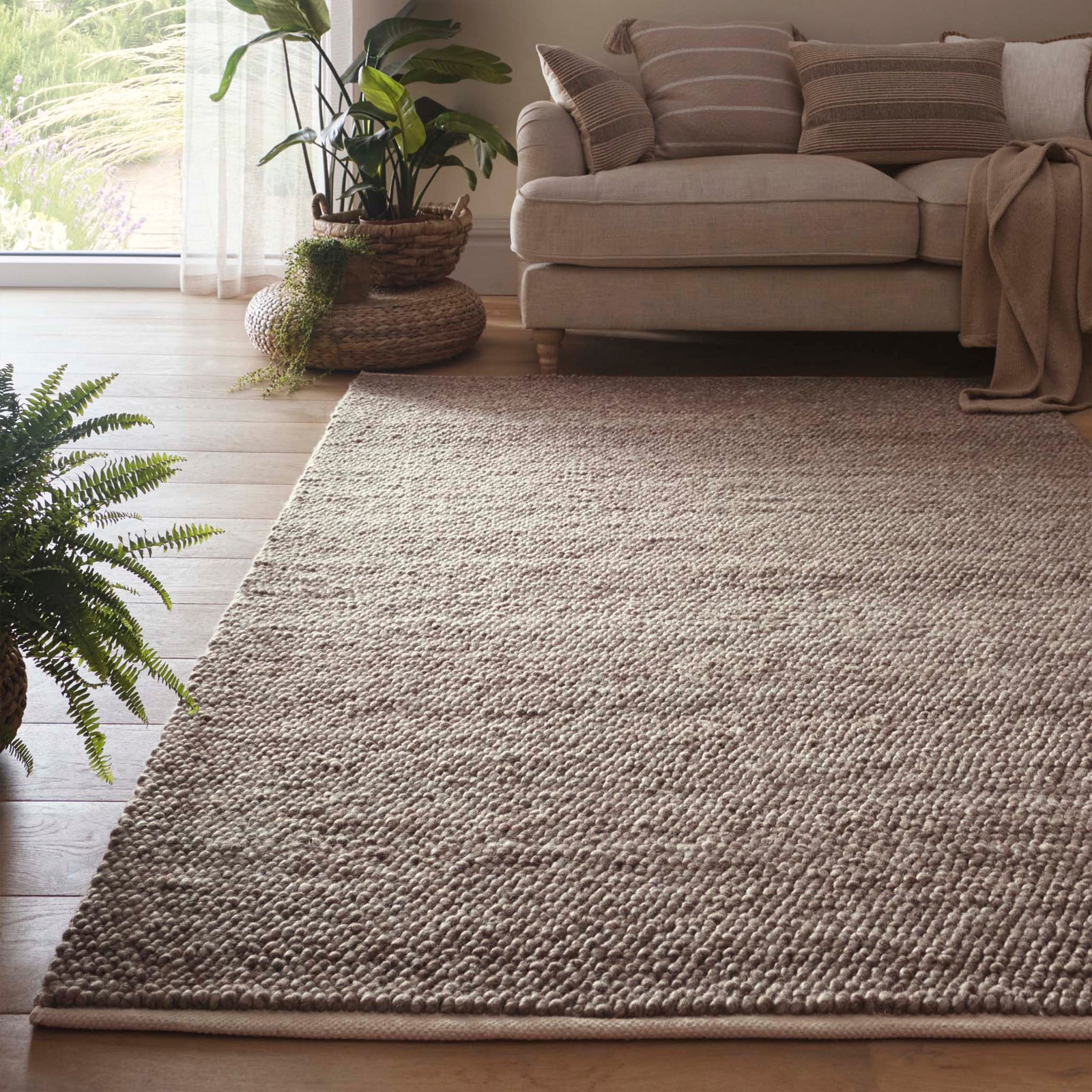 La Playa Rustic Brown Rug with a textured design, styled in a living room.