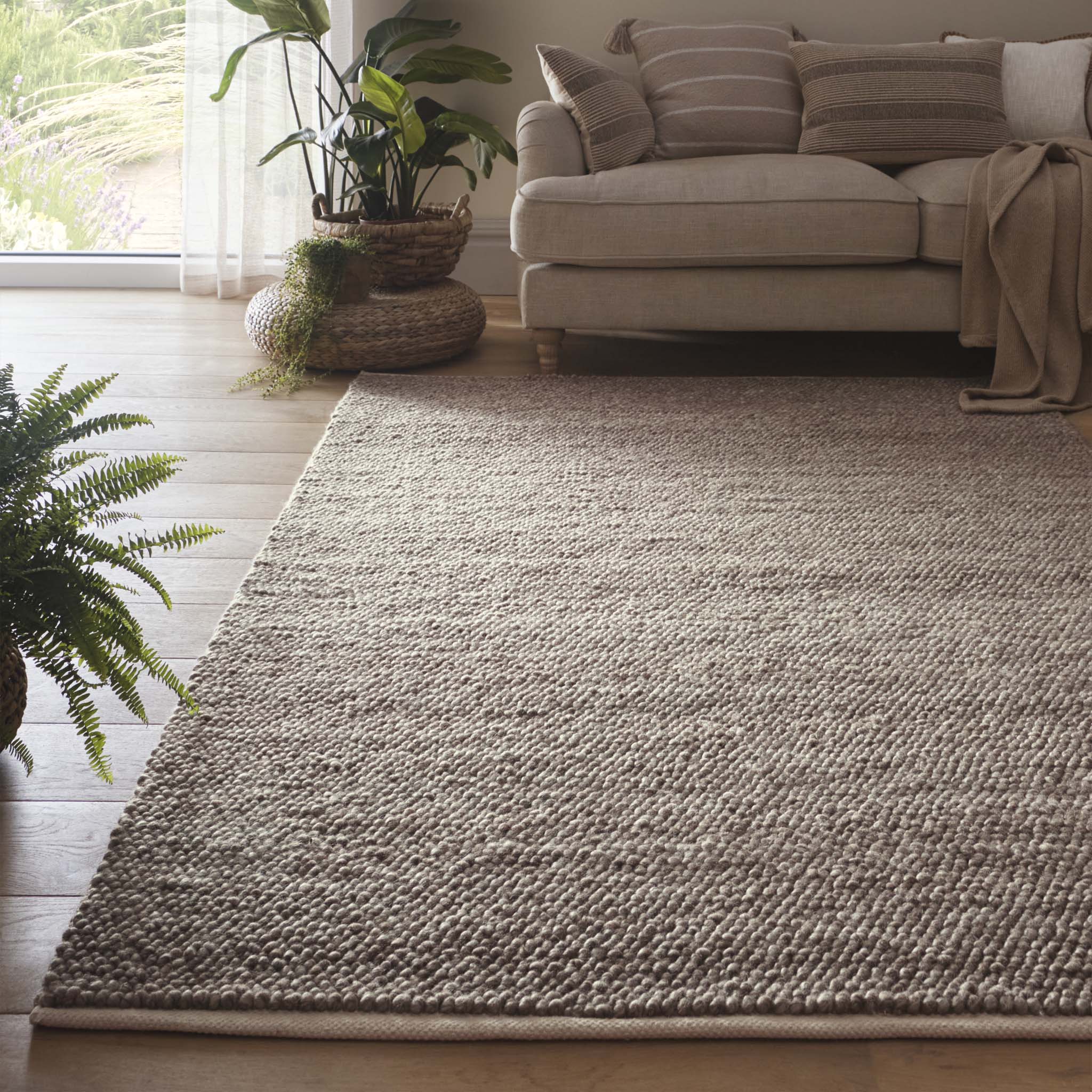 La Playa Rustic Brown Rug with a textured design, styled in a living room.