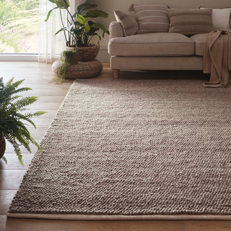 La Playa Rustic Brown Rug with a textured design, styled in a living room.