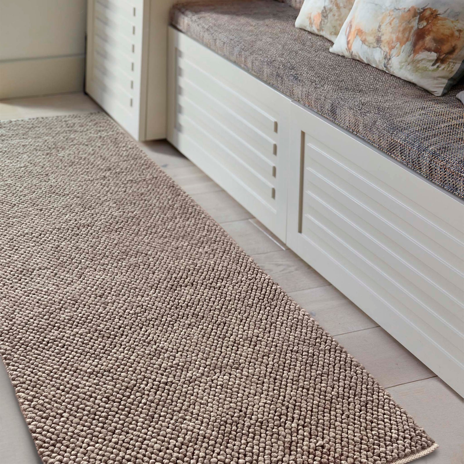 La Playa Rustic Brown Runner with a textured design, styled in a entryway.